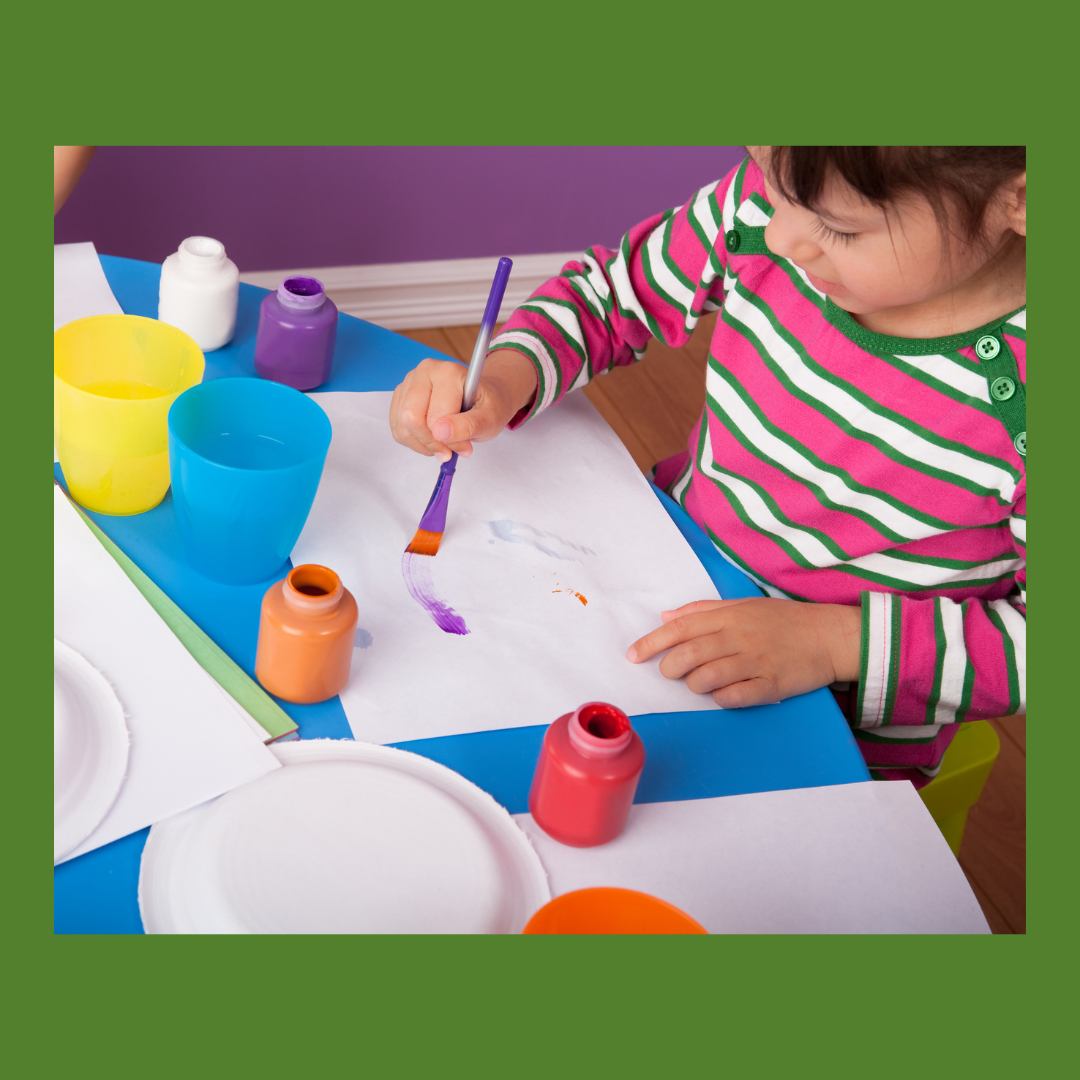 child painting at a table